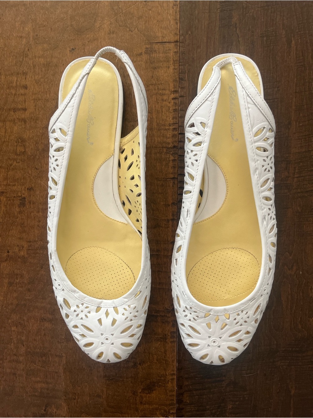 Eddie Bauer white leather slingback ballet flats with laser-cut floral designs.